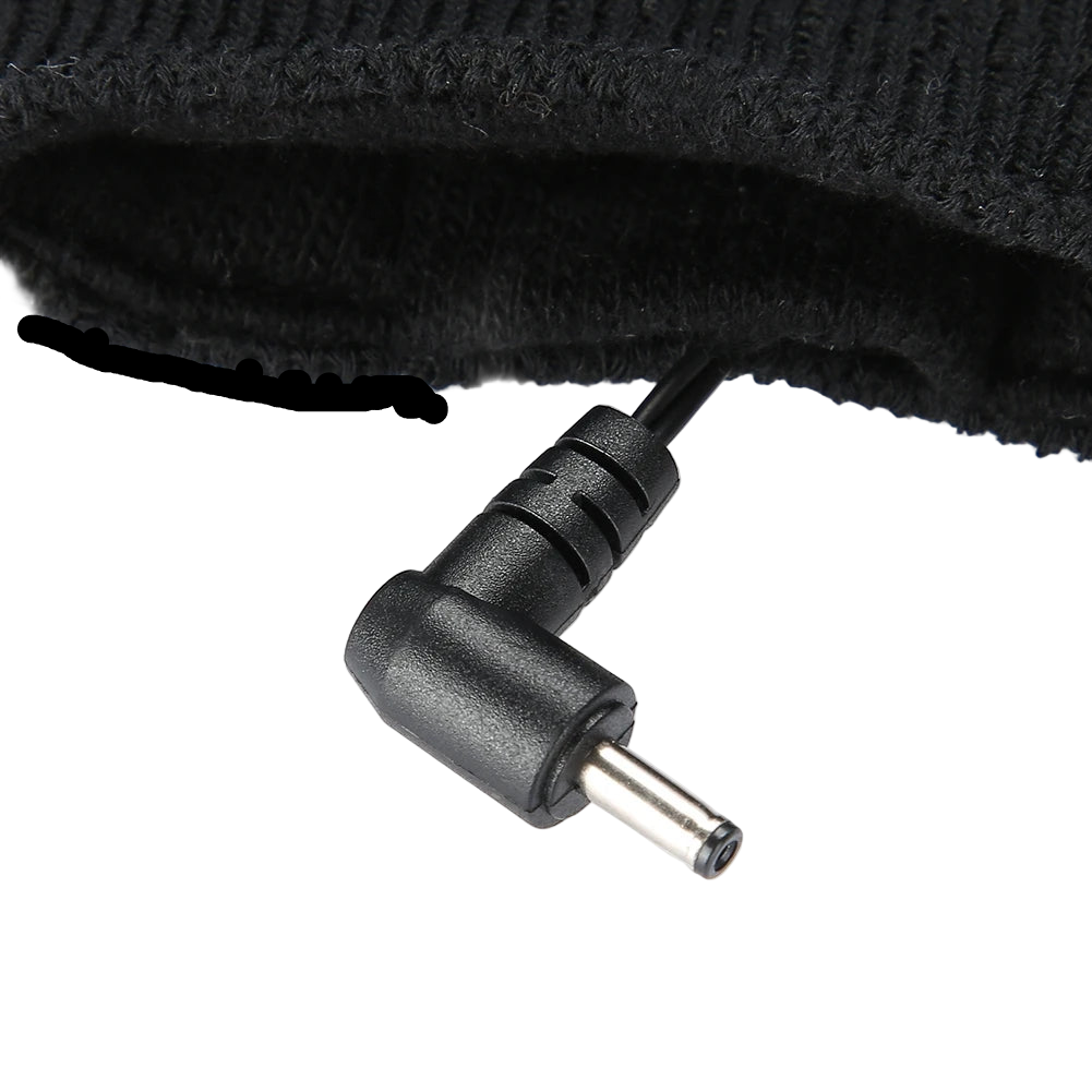 Black power adapter plug on a white background